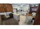 Kitchen with breakfast bar, white appliances, floral wallpaper, wood paneling, and a dining table at 9540 Shore Dr. # 1N, Myrtle Beach, SC 29572