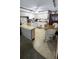 Kitchen with breakfast bar, white appliances, floral wallpaper, wood paneling, and a dining table at 9540 Shore Dr. # 1N, Myrtle Beach, SC 29572