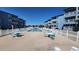 Outdoor pool with lots of seating, surrounded by blue condos under a bright blue sky at 9540 Shore Dr. # 1N, Myrtle Beach, SC 29572