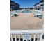 Outdoor pool with chairs and tables, a 'No Smoking' sign visible on the white fence at 9540 Shore Dr. # 1N, Myrtle Beach, SC 29572