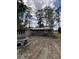 View of rear of home featuring chairs and a fire pit at 972 Mount Carmel Rd., Hemingway, SC 29554