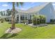 Picture of expansive backyard with lush green lawn, mature landscaping, and a charming patio area, ideal for relaxation and entertainment at 1010 Graybill Lane, North Myrtle Beach, SC 29582