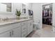 Modern bathroom with dual vanities, granite countertops, and a walk-in closet access at 1010 Graybill Lane, North Myrtle Beach, SC 29582