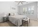 Bright bedroom with a patterned bedspread, a ceiling fan, and plantation shutters at 1010 Graybill Lane, North Myrtle Beach, SC 29582