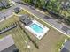 Aerial shot of a sparkling community pool with lounge chairs surrounded by lush greenery, ideal for summer relaxation at 1010 Graybill Lane, North Myrtle Beach, SC 29582