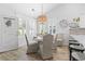 Charming dining area features a white round table, stylish chairs, and a unique light fixture at 1010 Graybill Lane, North Myrtle Beach, SC 29582