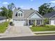 Charming two-story home with light blue siding, an attached two-car garage, and well-manicured landscaping at 1010 Graybill Lane, North Myrtle Beach, SC 29582