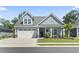 Inviting home exterior with a well-manicured lawn and charming front porch, creating a welcoming curb appeal at 1010 Graybill Lane, North Myrtle Beach, SC 29582