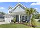 Beautiful two-story home with a manicured lawn, attached garage, and inviting front porch, showcasing its charming curb appeal at 1010 Graybill Lane, North Myrtle Beach, SC 29582