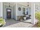 Inviting front porch featuring stone accents, decorative plants, and a cozy bench for relaxing at 1010 Graybill Lane, North Myrtle Beach, SC 29582