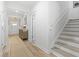Bright hallway featuring wood floors, staircase, and decoratively furnished foyer at 1010 Graybill Lane, North Myrtle Beach, SC 29582
