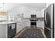 Modern kitchen with white cabinets, stainless steel appliances, and a spacious center island at 1010 Graybill Lane, North Myrtle Beach, SC 29582