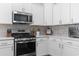 Modern kitchen with white cabinets, stainless steel appliances, and tile backsplash at 1010 Graybill Lane, North Myrtle Beach, SC 29582