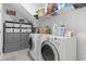 Organized laundry room with washer, dryer, shelving, and storage cabinets at 1010 Graybill Lane, North Myrtle Beach, SC 29582