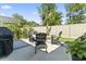 Outdoor patio with a dining set and a grill, surrounded by a fenced yard at 1010 Graybill Lane, North Myrtle Beach, SC 29582