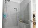 Sleek walk-in shower with gray tiling, a built-in seat, and modern fixtures at 1010 Graybill Lane, North Myrtle Beach, SC 29582