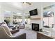 Bright sunroom with large windows, a fireplace, comfortable seating, and neutral decor at 1010 Graybill Lane, North Myrtle Beach, SC 29582