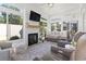 Bright sunroom with large windows, a fireplace, comfortable seating, and neutral decor at 1010 Graybill Lane, North Myrtle Beach, SC 29582