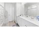 Bright bathroom featuring a double sink vanity, large mirror and white cabinets at 1015 Saltgrass Way, Myrtle Beach, SC 29588