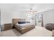 Primary bedroom with a wooden bed frame, neutral tones, and soft carpeting at 1015 Saltgrass Way, Myrtle Beach, SC 29588