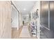 Inviting entryway with hardwood floors, decor, and a rustic barn door at 1015 Saltgrass Way, Myrtle Beach, SC 29588