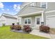 Charming home featuring a welcoming porch, landscaped yard and attached garage at 1015 Saltgrass Way, Myrtle Beach, SC 29588