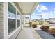 This covered front porch features classic columns, a concrete walkway, and landscaped beds at 1015 Saltgrass Way, Myrtle Beach, SC 29588