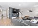 Cozy living room with modern decor, plank accent wall and ample seating at 1015 Saltgrass Way, Myrtle Beach, SC 29588