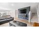Open-concept living room with plank wall accent, leading to a modern kitchen at 1015 Saltgrass Way, Myrtle Beach, SC 29588