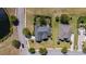 An aerial view shows the house with a dark roof nestled between well-maintained lawns and surrounded by lush trees at 1028 Whooping Crane Dr., Conway, SC 29526