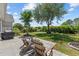 Charming backyard patio with Adirondack chairs, complemented by a lush lawn and mature trees at 1028 Whooping Crane Dr., Conway, SC 29526