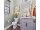 Cozy bathroom with gray walls, modern fixtures, granite countertops, and a toilet next to a window at 1028 Whooping Crane Dr., Conway, SC 29526