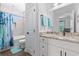 Bright bathroom featuring granite countertop, modern fixtures, tub, and shower with decorative blue curtain at 1028 Whooping Crane Dr., Conway, SC 29526