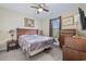 Comfortable bedroom with a ceiling fan, a wooden frame bed, and a window with natural light at 1028 Whooping Crane Dr., Conway, SC 29526