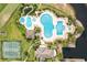 Aerial view showcasing the community pool, tennis courts and verdant landscaping at 1028 Whooping Crane Dr., Conway, SC 29526