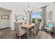 Charming dining room featuring a rectangular wood table, comfortable upholstered chairs, and a large window at 1028 Whooping Crane Dr., Conway, SC 29526