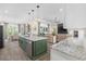 Open-concept kitchen featuring a large island, stainless steel appliances, and seamless flow into the living and dining areas at 1028 Whooping Crane Dr., Conway, SC 29526