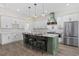 Modern kitchen with a large island, granite countertops, stainless steel appliances, and a stylish range hood at 1028 Whooping Crane Dr., Conway, SC 29526