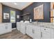 Stylish laundry room with dark walls, white cabinets, modern appliances, and unique animal-themed decor at 1028 Whooping Crane Dr., Conway, SC 29526