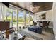 Relaxing screened porch with wicker furniture, fire pit, ceiling fan, and views of the outdoor greenery at 1028 Whooping Crane Dr., Conway, SC 29526
