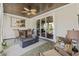 Cozy screened porch with wicker furniture, fire pit, sliding glass doors, and a wooden ceiling with fan at 1028 Whooping Crane Dr., Conway, SC 29526