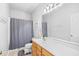 Bright bathroom featuring a shower with gray curtain and a vanity with ample counter space at 106 Willow Ridge Rd., Myrtle Beach, SC 29588
