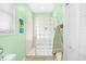 Well-lit bathroom with glass block shower, neutral tile, and decorative beach-themed wall art at 106 Willow Ridge Rd., Myrtle Beach, SC 29588