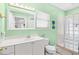 Charming bathroom with updated vanity, glass block shower, and refreshing mint-green walls at 106 Willow Ridge Rd., Myrtle Beach, SC 29588