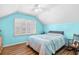 Cozy bedroom with blue walls, wood floors, plantation shutters, and a ceiling fan at 106 Willow Ridge Rd., Myrtle Beach, SC 29588