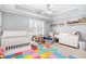 Cozy bedroom with white furniture, natural light, and colorful playmat at 106 Willow Ridge Rd., Myrtle Beach, SC 29588