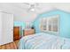 Bright bedroom features a ceiling fan, window with plantation shutters, and wood-look laminate flooring at 106 Willow Ridge Rd., Myrtle Beach, SC 29588