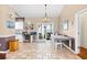 Light-filled dining area features neutral paint and elegant chandelier, seamlessly flowing into kitchen and outdoor patio at 106 Willow Ridge Rd., Myrtle Beach, SC 29588