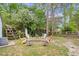 Backyard fire pit with seating and wooded surroundings at 106 Willow Ridge Rd., Myrtle Beach, SC 29588