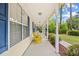 Spacious covered front porch with yellow rocking chairs and plenty of room for relaxing at 106 Willow Ridge Rd., Myrtle Beach, SC 29588